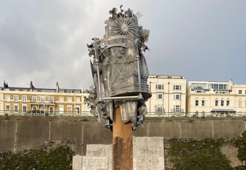 Beachcomber sculptures by Anna Dumitriu and Alex May. An abstract metal sculpture mounted on a wooden pole on Brighton seafront.